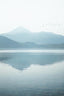 Blue Mountains Reflecting In A Fjord Near Tromso